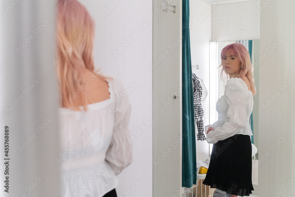 Woman Trying On Clothes And Looking The Mirror Woman Trying On Clothes And Looking The Mirror