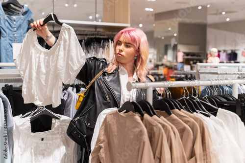 Woman Holding Blouse In Clothes Shop