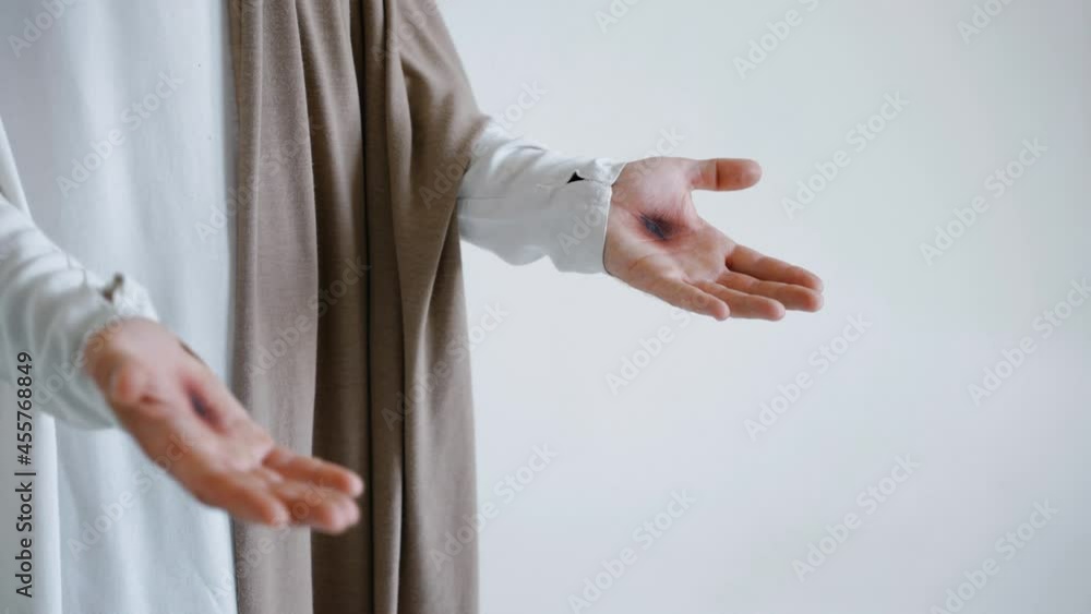 Jesus' hands with stigmata on a white background. Studio. High quality 4k footage Jesus' hands with stigmata on a white background. Studio. High quality 4k footage