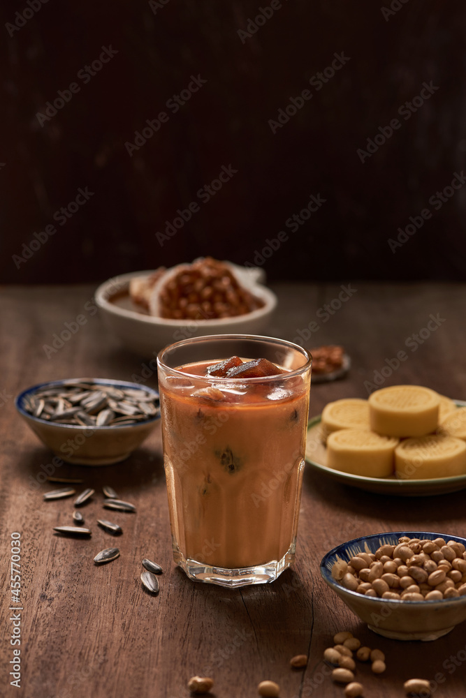 Ice milk coffee on wood background with nuts and snack. Ice milk coffee on wood background with nuts and snack.