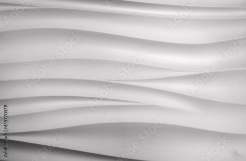 Photo of the texture of a ceramic white tile with wavy stripes. Decorative panels for painting