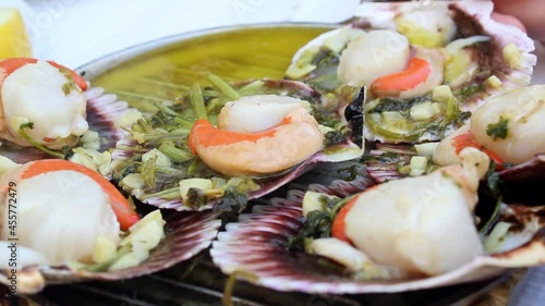 Eating fresh Variegated scallop photo