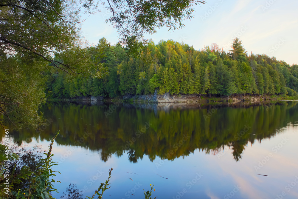 calm river with trees and rock reflections natural forest environment East Angus Quebec