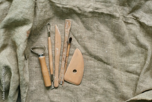 wooden tools for working with clay and ceramics on a linen background