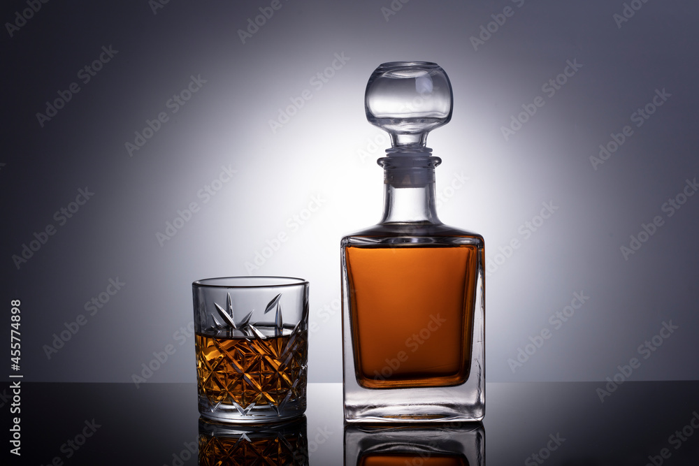 Cognac or brandy glass isolated on gray white background with clipping path. Decander with cognac or brandy Cognac or brandy glass isolated on gray white background with clipping path. Decander with cognac or brandy