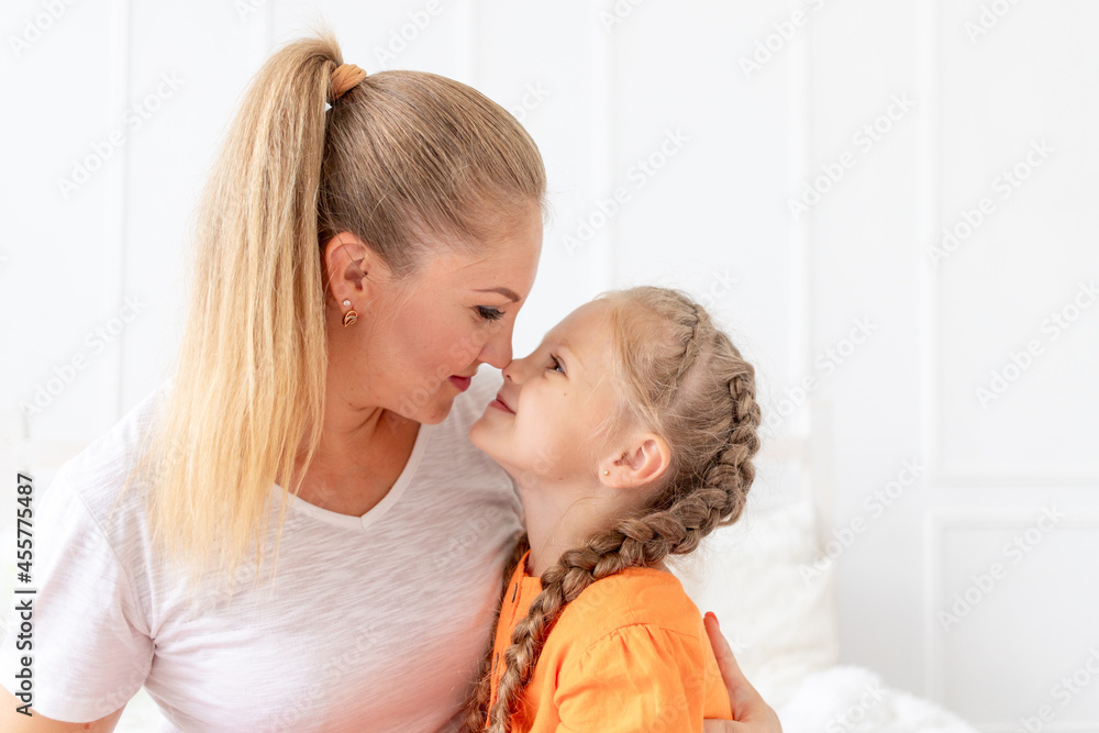 portrait of a mother and daughter looking at each other, the concept of love and motherhood or mother's day portrait of a mother and daughter looking at each other, the concept of love and motherhood or mother's day