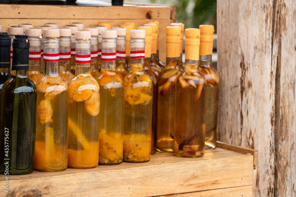 Bottles of artisan liquor, macerated with various fruits. Bottles of