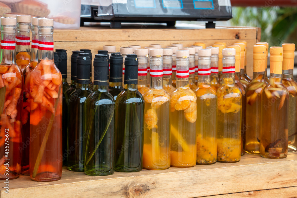 Bottles of artisan liquor, macerated with various fruits. Bottles of