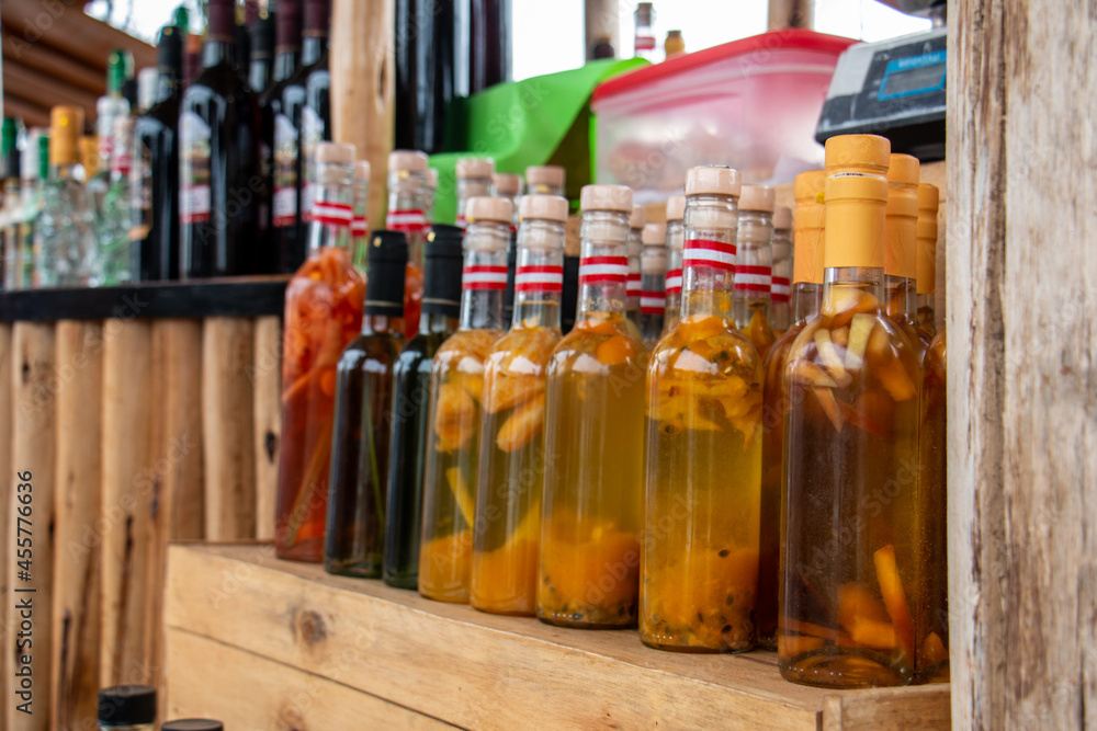 Bottles of artisan liquor, macerated with various fruits. Bottles of