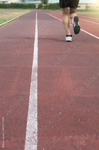 detail of an athlete's feet running on a street of an athletics track