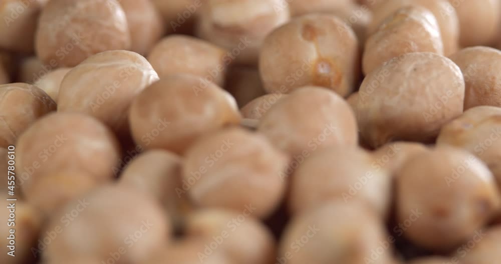Raw chickpeas, rotation. Chickpeas, close-up dolly shot. Macro footage of chickpeas beans. Food cooking video. Raw chickpeas, rotation. Chickpeas, close-up dolly shot. Macro footage of chickpeas beans. Food cooking video.