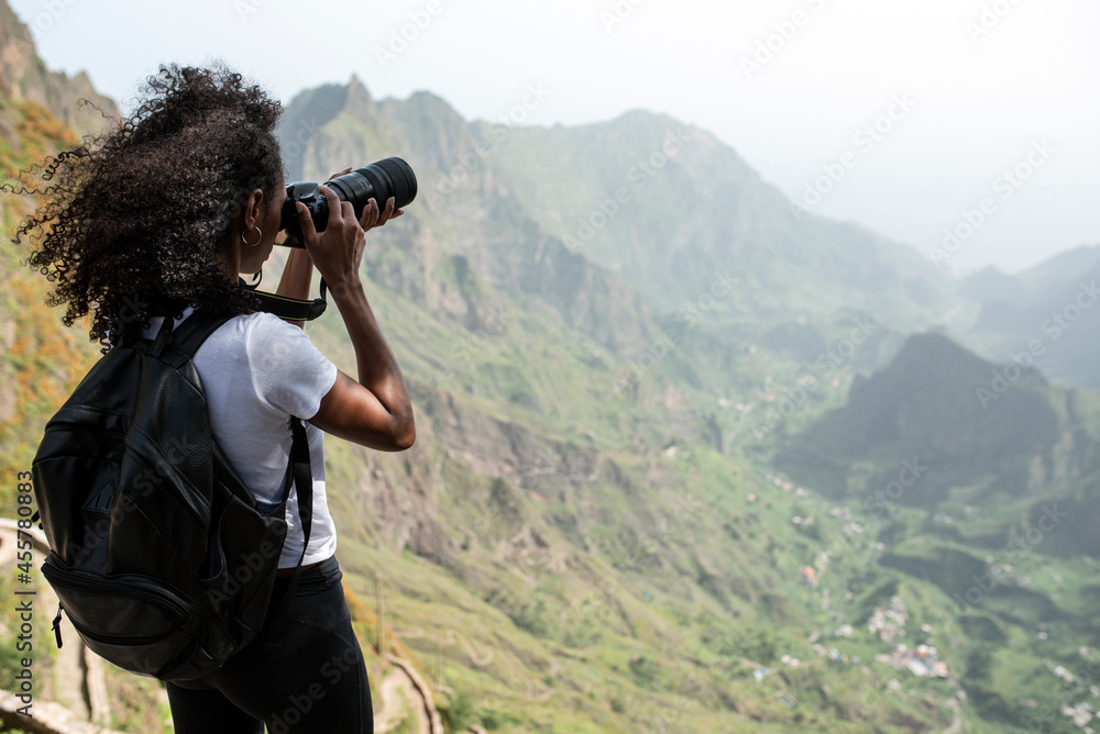 Beautiful black woman with camera taking photos Beautiful black woman with camera taking photos