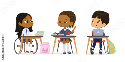 Happy elementary pupils at lesson diversity inclusion education class talking together vector flat illustration. Cute girl in wheelchair wearing school uniform greeting multiracial classmates isolated
