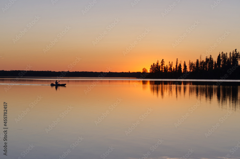 A Lone Boater drifting across Astotin Lake at Sunset