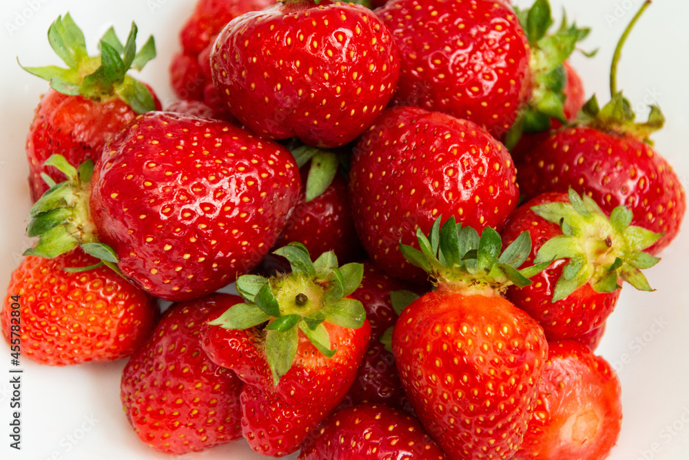 Fresh ripe strawberries close-up on a white background. Strawberry texture. Strawberry harvest. Fresh ripe strawberries close-up on a white background. Strawberry texture. Strawberry harvest.