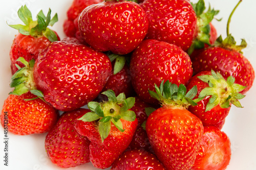 Fresh ripe strawberries close-up on a white background. Strawberry texture. Strawberry harvest.