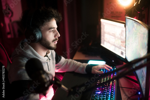 Concentrated live streamer playing video games
 photo