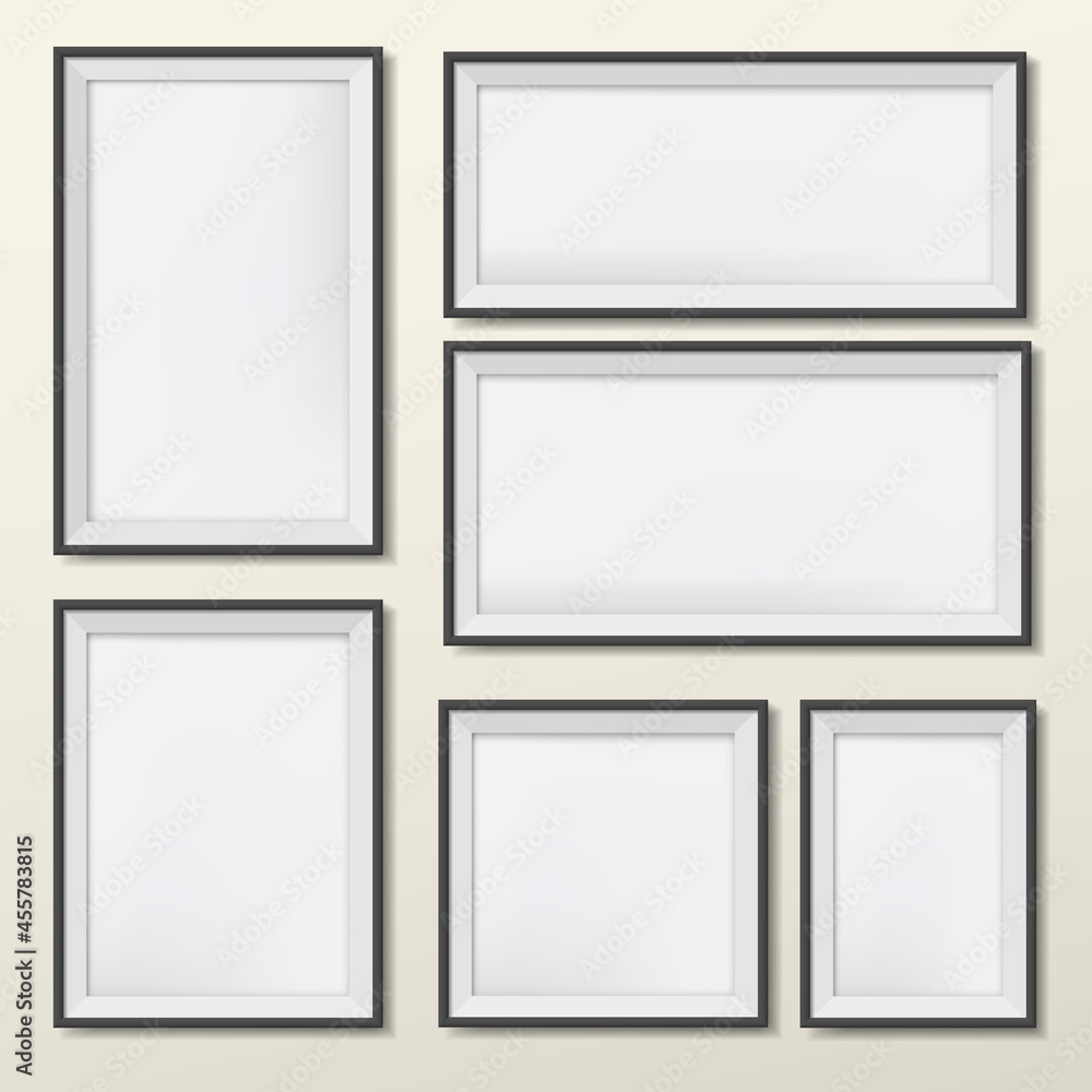 Blank and different size picture frames are on wall Blank and different size picture frames are on wall