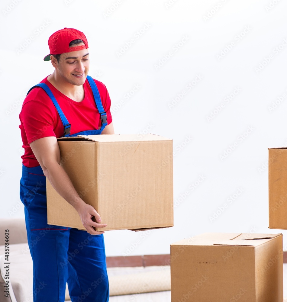 Contractor worker moving boxes during office move Contractor worker moving boxes during office move