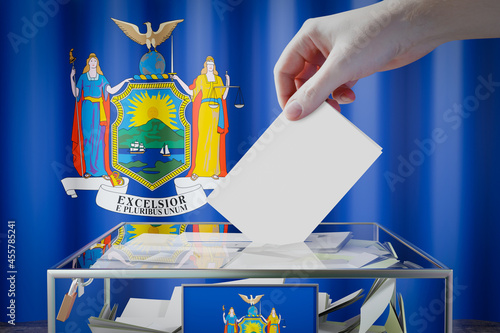 New York flag, hand dropping ballot card into a box - voting, election concept - 3D illustration photo