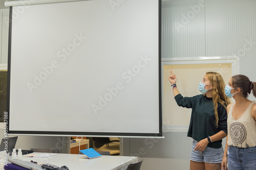 Two young womans giving a business presentation  photo