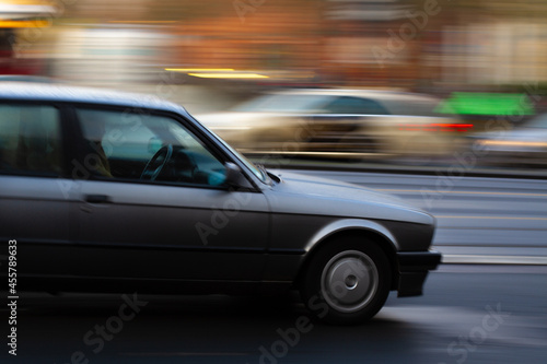 panning shot of a car with blurred background, taxi in the background symbolizing a busy street and dense traffic © Felix Busse Phtgrphy