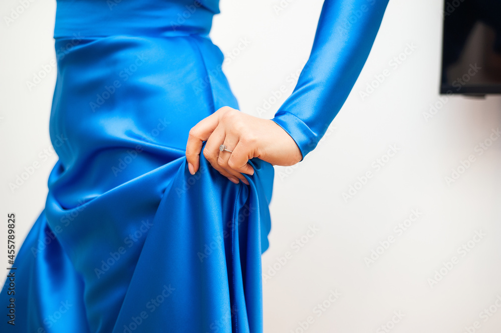 Silk blue woman dress on the white background
