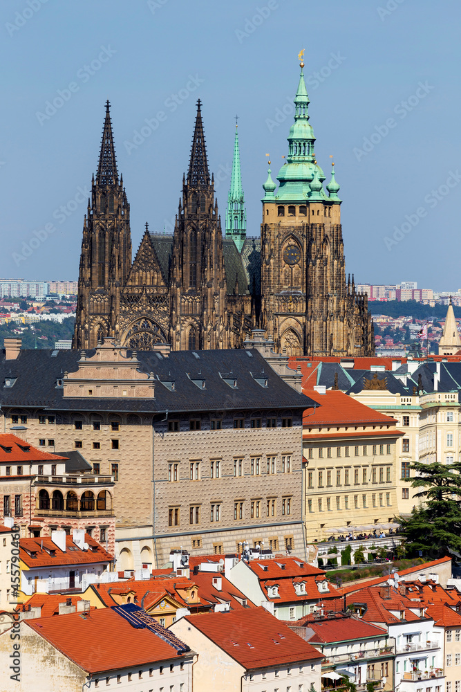 Fototapeta premium Autumn Prague City with gothic Castle and the colorful Nature with Trees from the Hill Petrin, Czech Republic