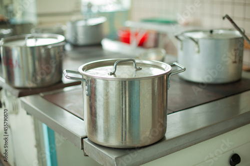 Large pot for cooking. Kitchen utensils in the dining room. Stainless steel water tank.