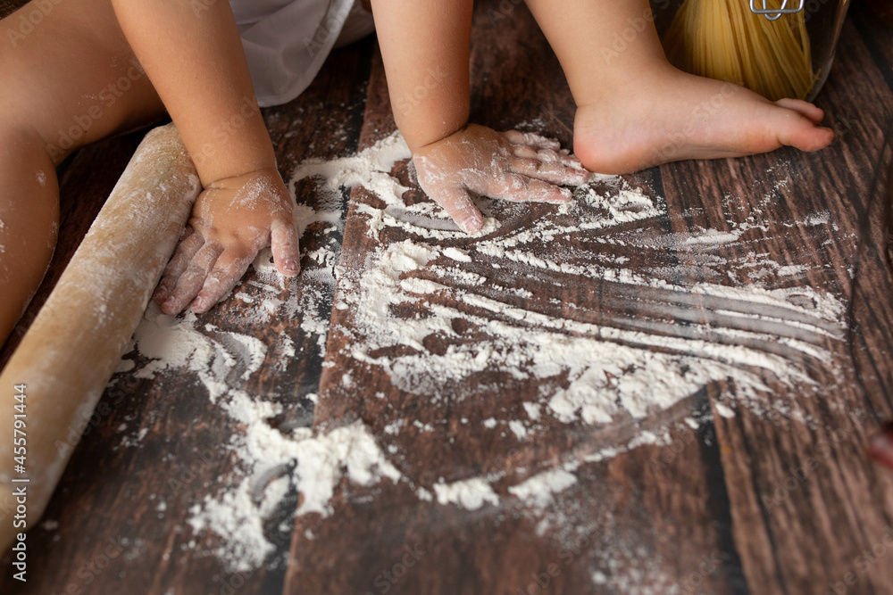 a child's hand in the flour