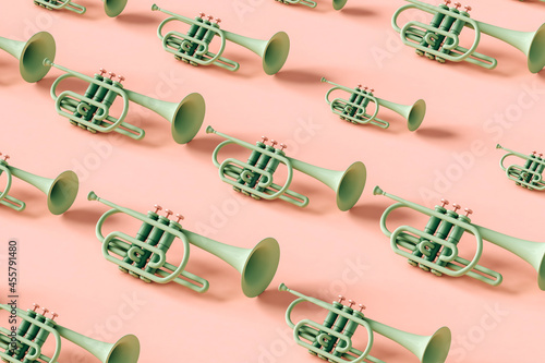 Green trumpets in different sizes on pink background