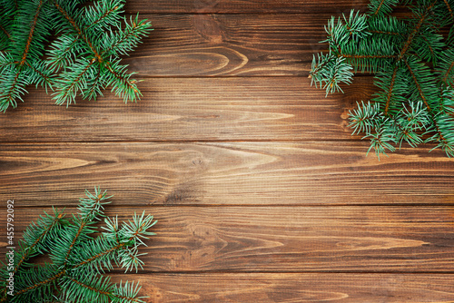 Fir branches on a wooden rustic background.
