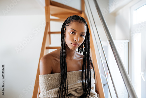 Woman with braided long hair sitting in the bed photo