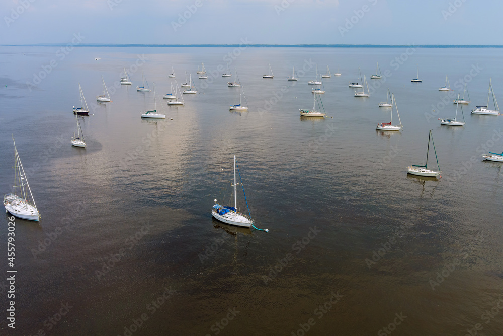 Many boats in a dock, harbor on boat floating on the ocean