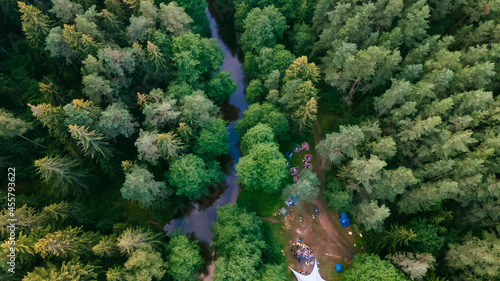 Forest with a winding river at sunset. Aerial photography with a drone. Nature concept.