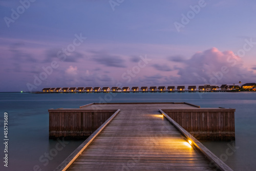 Wallpaper Mural hard rock hotel pier end on a turquoise water at sunset time. Crossroads Maldives, july 2021 Torontodigital.ca