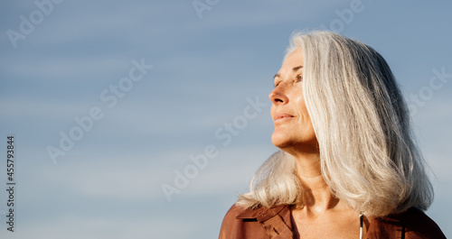 Active mature woman enjoying the beach in the morning