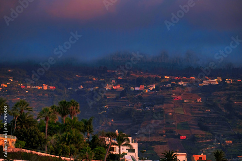 Puerto de la Cruz and the Orotava Valley at sunset clouds envelop the mountains