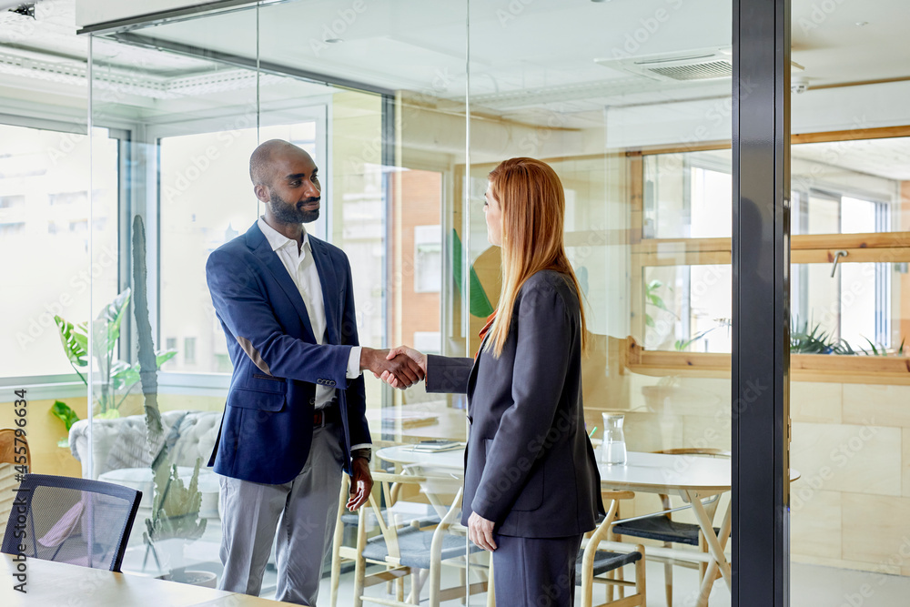 Businessman greeting businesswoman Businessman greeting businesswoman