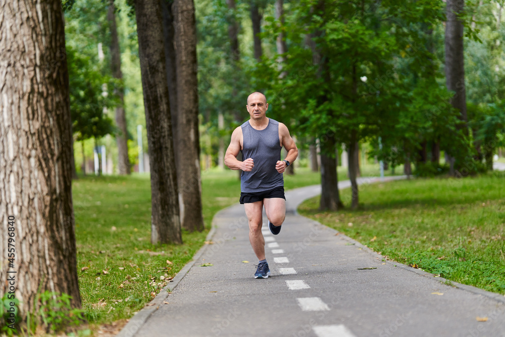 Marathon runner training in the park Marathon runner training in the park
