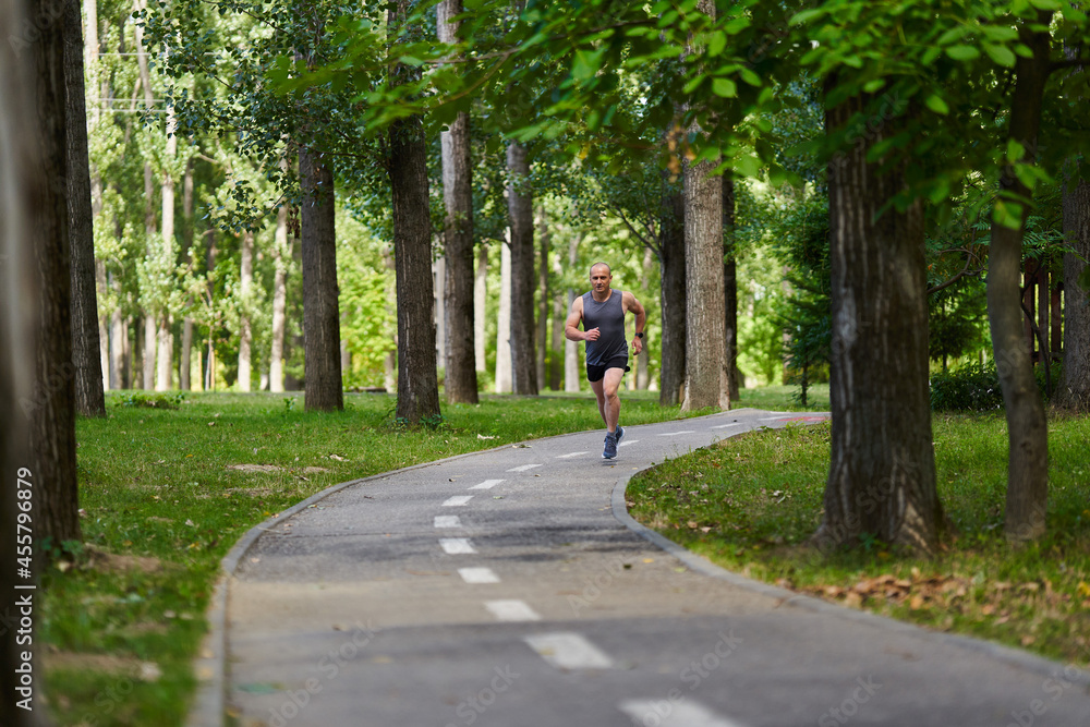 Marathon runner training in the park Marathon runner training in the park