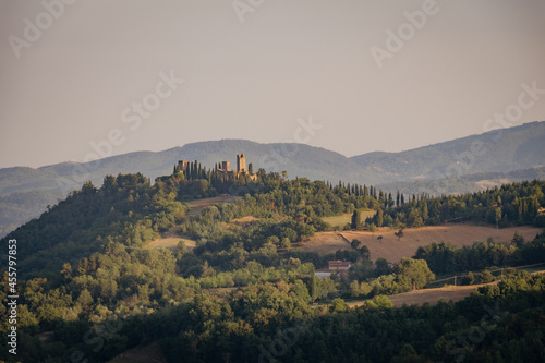 ruins of an ancient medieval castle at sunset in the Tuscan hills