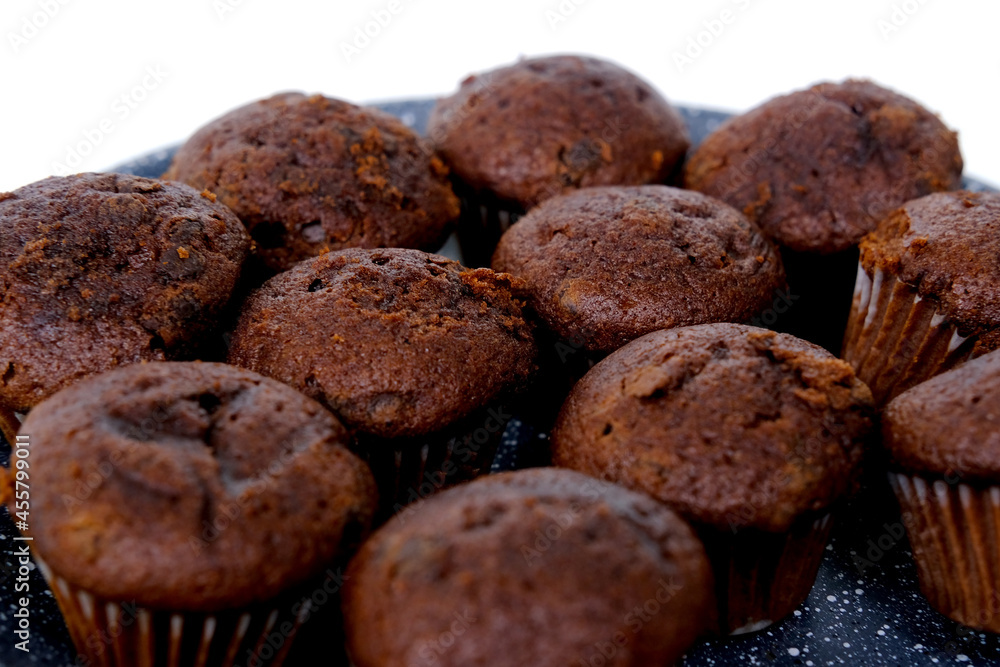 lot of chocolate muffins on a gray plate, high-calorie food concept, sweets , food pleasure, baby treat lot of chocolate muffins on a gray plate, high-calorie food concept, sweets , food pleasure, baby treat