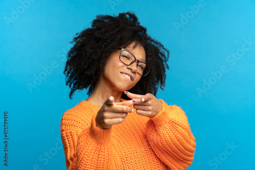 You what we need: excited african woman choosing you and gesturing point fingers front. Happy black female directing to camera, wink and bite lip. Career development, job offer and join team concept photo