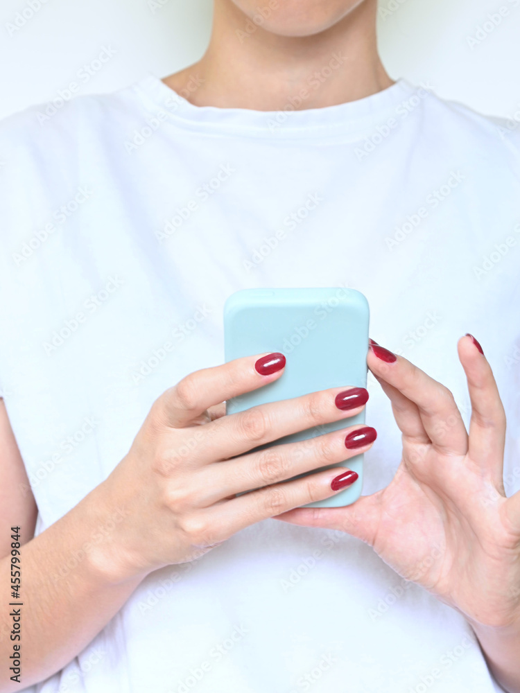 Woman hands holding a smart phone, white background with copy space. Woman hands holding a smart phone, white background with copy space.