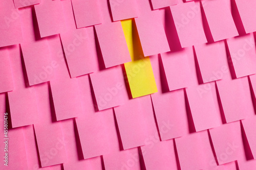 Pink Post it reminders with single yellow one photo