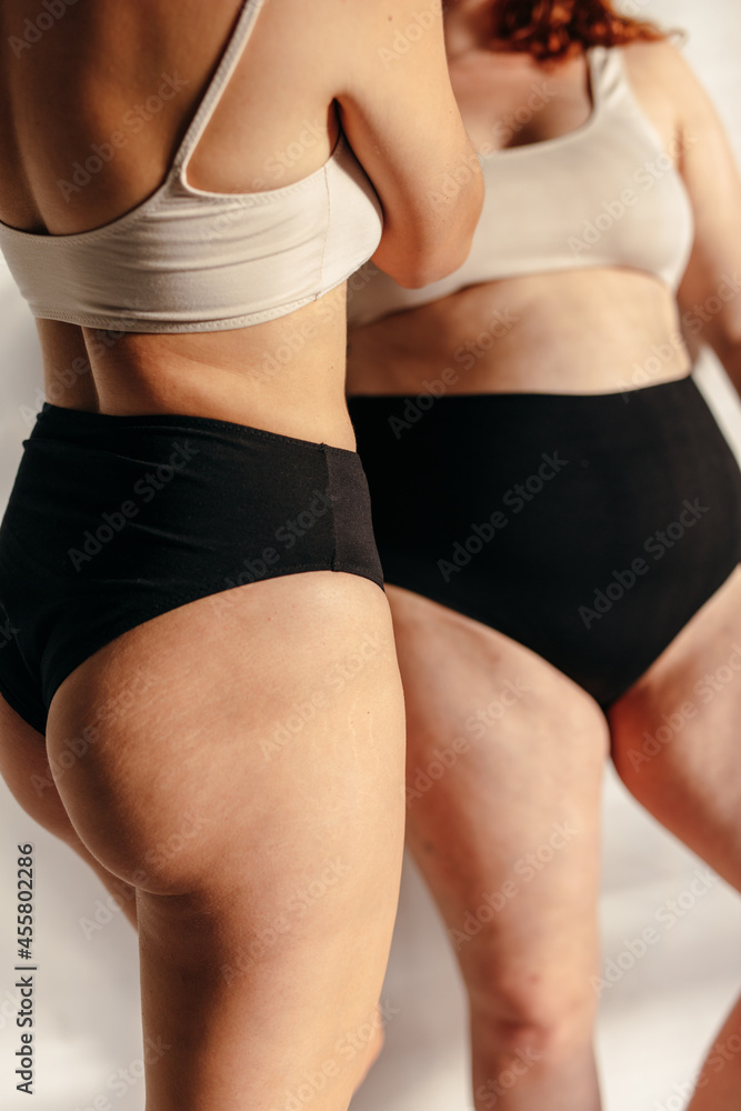 Cropped image of two women with different body type Cropped image of two women with different body type