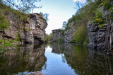 Nature Landscape view of rocky canyon and a calm river with water reflection at the Buky village, Ukraine