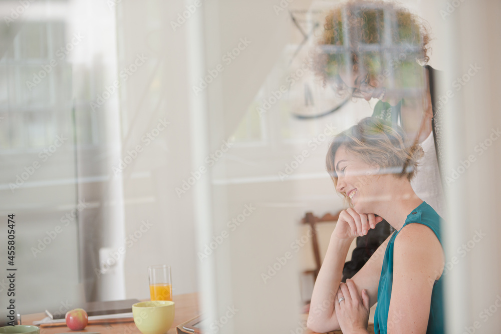 Women talking and smiling in office Women talking and smiling in office