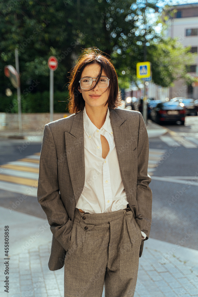 non-binary person in a man's suit in the city non-binary person in a man's suit in the city